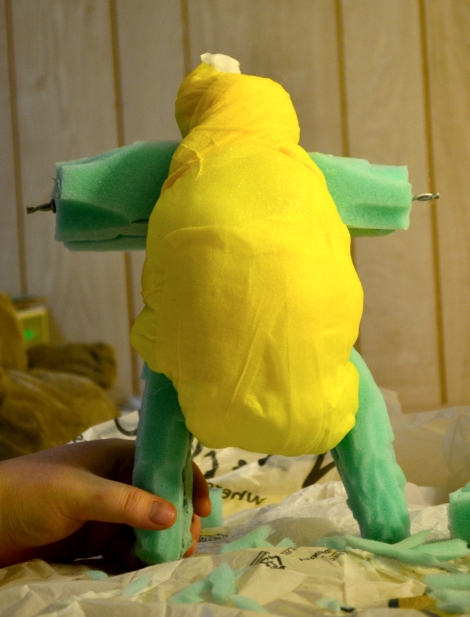 The torso and neck are wrapped securely! It's legs have just begun to take shape.