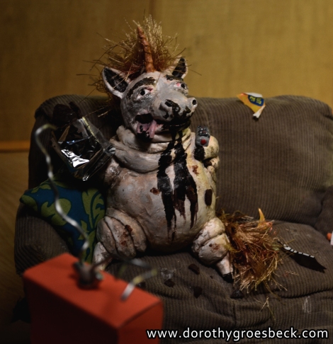 Here he is in all of his glory! I also made a TV I made from a cereal box. I then covered it in orange construction paper. The antenna is just armature wire sitting on a wingnut. His mane and tail are cut from a ball of fancy scarf yarn.